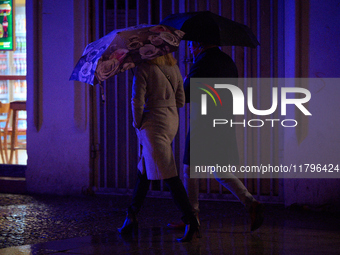 A pedestrian with an umbrella is seen in a shopping street during rainfall in Warsaw, Poland on 20 November, 2024. (