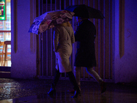 A pedestrian with an umbrella is seen in a shopping street during rainfall in Warsaw, Poland on 20 November, 2024. (