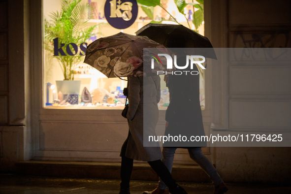 A pedestrian with an umbrella is seen in a shopping street during rainfall in Warsaw, Poland on 20 November, 2024. 