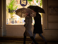 A pedestrian with an umbrella is seen in a shopping street during rainfall in Warsaw, Poland on 20 November, 2024. (