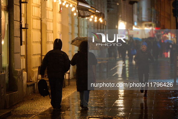 A pedestrian with an umbrella is seen in a shopping street during rainfall in Warsaw, Poland on 20 November, 2024. 