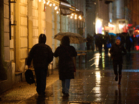 A pedestrian with an umbrella is seen in a shopping street during rainfall in Warsaw, Poland on 20 November, 2024. (