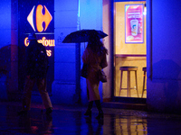 A pedestrian with an umbrella is seen in a shopping street during rainfall in Warsaw, Poland on 20 November, 2024. (