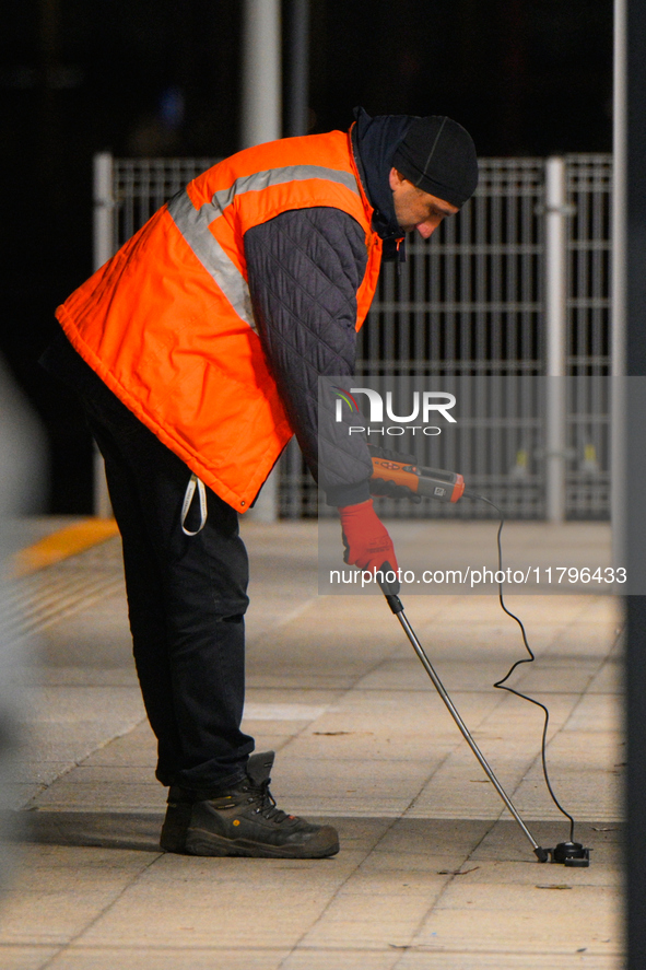 A worker is seen with a light meter on a train platform in Warsaw, Poland on 20 November, 2024. 