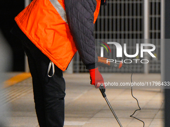 A worker is seen with a light meter on a train platform in Warsaw, Poland on 20 November, 2024. (