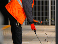 A worker is seen with a light meter on a train platform in Warsaw, Poland on 20 November, 2024. (