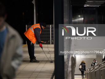 A worker is seen with a light meter on a train platform in Warsaw, Poland on 20 November, 2024. (