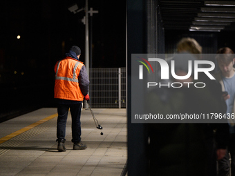 A worker is seen with a light meter on a train platform in Warsaw, Poland on 20 November, 2024. (