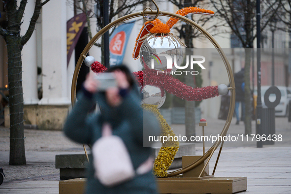 People walk past Christmas lights decoratoins prepared for the upcoming season in Warsaw, Poland on 18 November, 2024. Warsaw is an increasi...