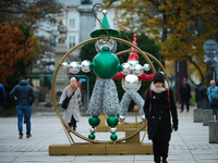 People walk past Christmas lights decoratoins prepared for the upcoming season in Warsaw, Poland on 18 November, 2024. Warsaw is an increasi...