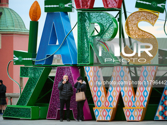 People walk past Christmas lights decoratoins prepared for the upcoming season in Warsaw, Poland on 18 November, 2024. Warsaw is an increasi...