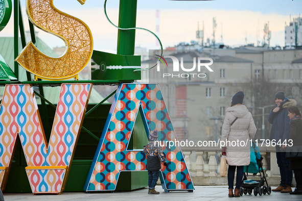 People walk past Christmas lights decoratoins prepared for the upcoming season in Warsaw, Poland on 18 November, 2024. Warsaw is an increasi...