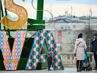 People walk past Christmas lights decoratoins prepared for the upcoming season in Warsaw, Poland on 18 November, 2024. Warsaw is an increasi...