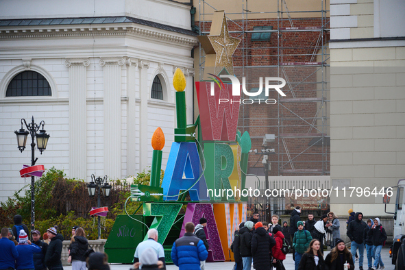 People walk past Christmas lights decoratoins prepared for the upcoming season in Warsaw, Poland on 18 November, 2024. Warsaw is an increasi...