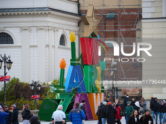 People walk past Christmas lights decoratoins prepared for the upcoming season in Warsaw, Poland on 18 November, 2024. Warsaw is an increasi...