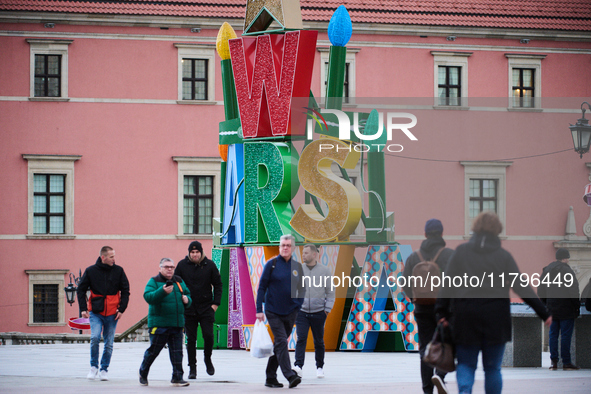 People walk past Christmas lights decoratoins prepared for the upcoming season in Warsaw, Poland on 18 November, 2024. Warsaw is an increasi...