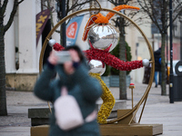 People walk past Christmas lights decoratoins prepared for the upcoming season in Warsaw, Poland on 18 November, 2024. Warsaw is an increasi...