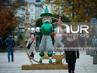 People walk past Christmas lights decoratoins prepared for the upcoming season in Warsaw, Poland on 18 November, 2024. Warsaw is an increasi...