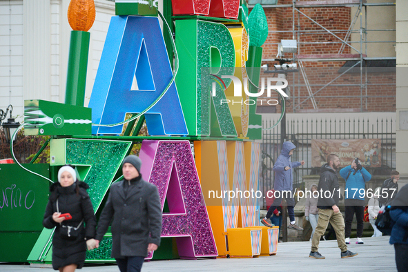 People walk past Christmas lights decoratoins prepared for the upcoming season in Warsaw, Poland on 18 November, 2024. Warsaw is an increasi...