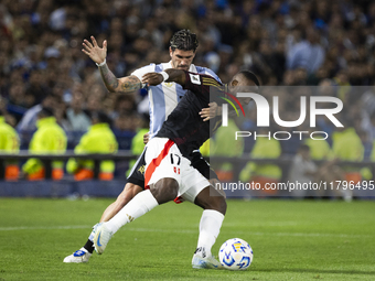 Peru's Luis Advincula competes with Argentina's Rodrigo De Paul during the 2026 FIFA World Cup South American qualifiers football match betw...