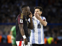 Luis Advincula of Peru and Lionel Messi of Argentina chat with their mouths covered during the South American qualifiers soccer match for th...