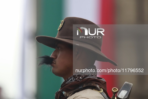 A person takes part in the military civic parade for the commemoration of the 114th anniversary of the Mexican Revolution at the main square...