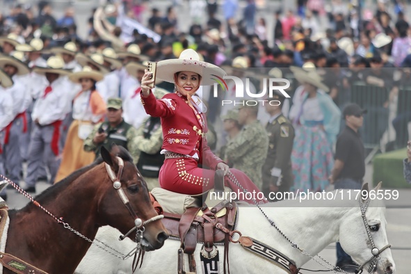 A charro woman takes part in the military civic parade for the commemoration of the 114th anniversary of the Mexican Revolution at the main...