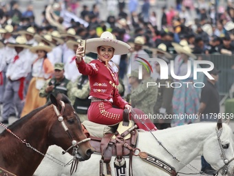 A charro woman takes part in the military civic parade for the commemoration of the 114th anniversary of the Mexican Revolution at the main...