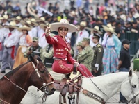 A charro woman takes part in the military civic parade for the commemoration of the 114th anniversary of the Mexican Revolution at the main...