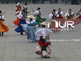 People participate in the military civic parade for the commemoration of the 114th anniversary of the Mexican Revolution at the main square...