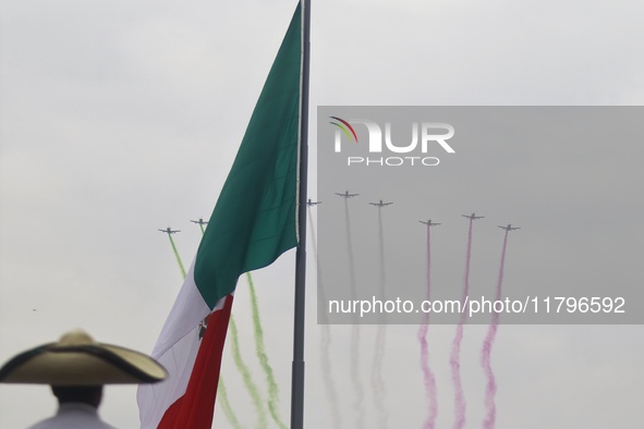 Pilots fly in the sky during the military civic parade for the commemoration of the 114th anniversary of the Mexican Revolution at the main...