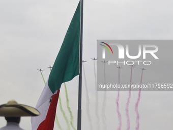 Pilots fly in the sky during the military civic parade for the commemoration of the 114th anniversary of the Mexican Revolution at the main...