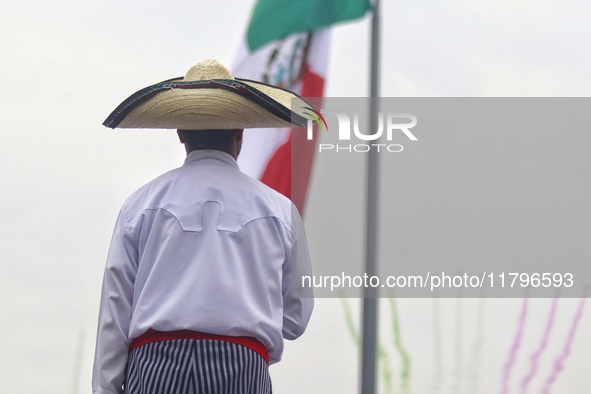 A person takes part in the military civic parade for the commemoration of the 114th anniversary of the Mexican Revolution at the main square...