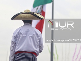 A person takes part in the military civic parade for the commemoration of the 114th anniversary of the Mexican Revolution at the main square...