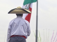 A person takes part in the military civic parade for the commemoration of the 114th anniversary of the Mexican Revolution at the main square...