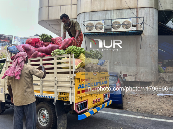 Workers unload sacks of fruits and vegetables from a truck in Thiruvananthapuram (Trivandrum), Kerala, India, on April 9, 2024. 