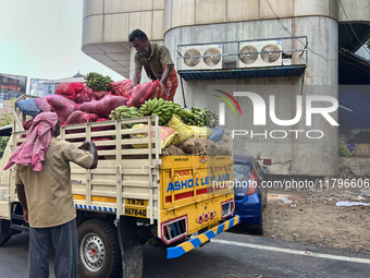 Workers unload sacks of fruits and vegetables from a truck in Thiruvananthapuram (Trivandrum), Kerala, India, on April 9, 2024. (