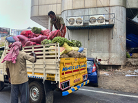 Workers unload sacks of fruits and vegetables from a truck in Thiruvananthapuram (Trivandrum), Kerala, India, on April 9, 2024. (