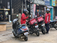 Zomato food delivery drivers pick up orders from a restaurant in Thiruvananthapuram (Trivandrum), Kerala, India, on April 9, 2024. (