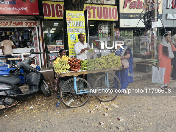 A man and his wife sell bananas from a small cart in the East Fort area of Thiruvananthapuram, Kerala, India, on April 9, 2024. 