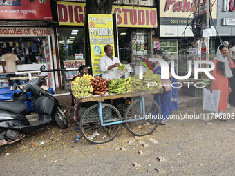 A man and his wife sell bananas from a small cart in the East Fort area of Thiruvananthapuram, Kerala, India, on April 9, 2024. (