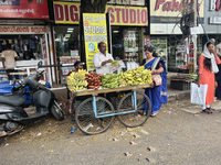 A man and his wife sell bananas from a small cart in the East Fort area of Thiruvananthapuram, Kerala, India, on April 9, 2024. (