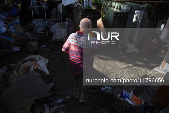 Residents clean their homes and try to save the remaining belongings after a flash flood hits Mekarbuana village, Karawang district, West Ja...