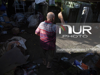 Residents clean their homes and try to save the remaining belongings after a flash flood hits Mekarbuana village, Karawang district, West Ja...