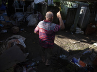 Residents clean their homes and try to save the remaining belongings after a flash flood hits Mekarbuana village, Karawang district, West Ja...