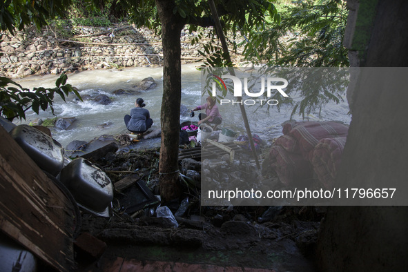 Residents clean their homes and try to save the remaining belongings after a flash flood hits Mekarbuana village, Karawang district, West Ja...