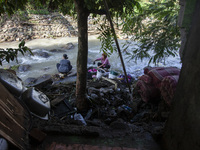 Residents clean their homes and try to save the remaining belongings after a flash flood hits Mekarbuana village, Karawang district, West Ja...