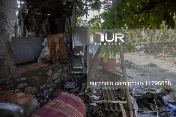 Residents clean their homes and try to save the remaining belongings after a flash flood hits Mekarbuana village, Karawang district, West Ja...