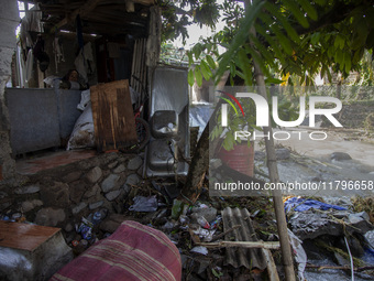 Residents clean their homes and try to save the remaining belongings after a flash flood hits Mekarbuana village, Karawang district, West Ja...