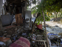 Residents clean their homes and try to save the remaining belongings after a flash flood hits Mekarbuana village, Karawang district, West Ja...